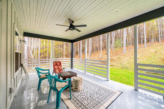 sunroom with ceiling fan and wood ceiling