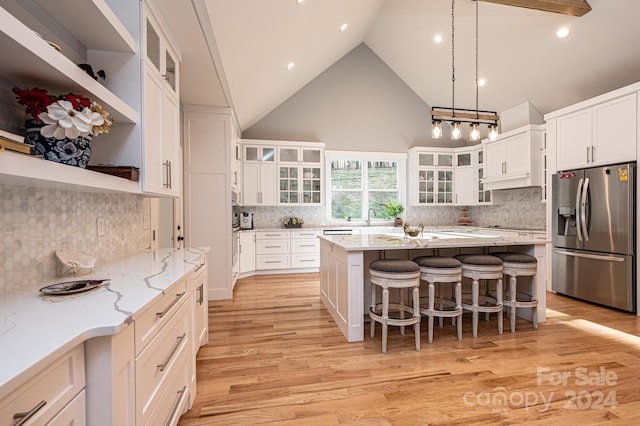 kitchen with white cabinetry, stainless steel fridge with ice dispenser, and light hardwood / wood-style floors