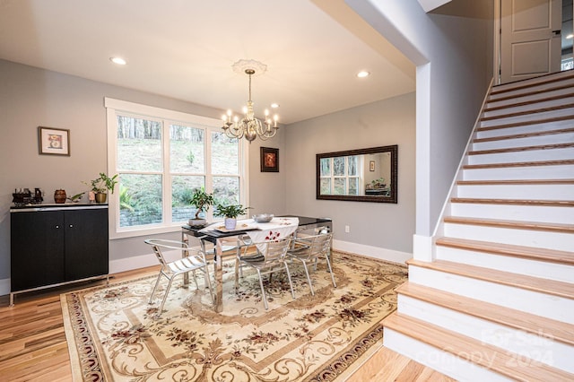 dining space featuring a chandelier and light hardwood / wood-style floors