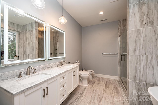 bathroom with vanity, toilet, an enclosed shower, and a bidet