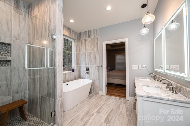 bathroom with vanity, plus walk in shower, and tile walls