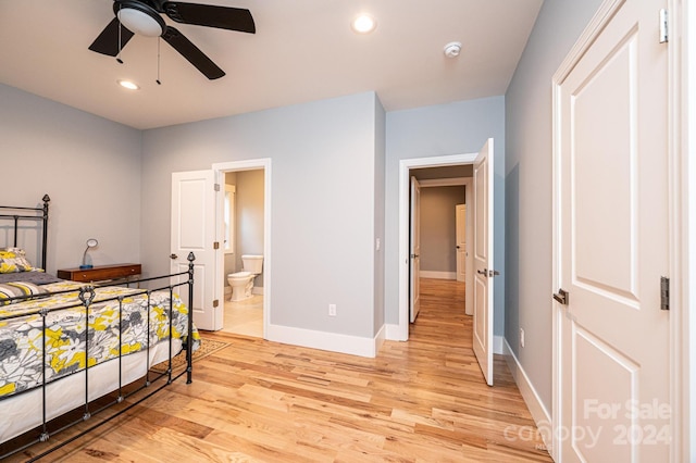 bedroom with ceiling fan, light wood-type flooring, and ensuite bath