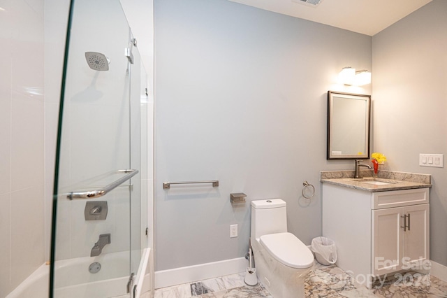 full bathroom with vanity, toilet, and shower / bath combination with glass door