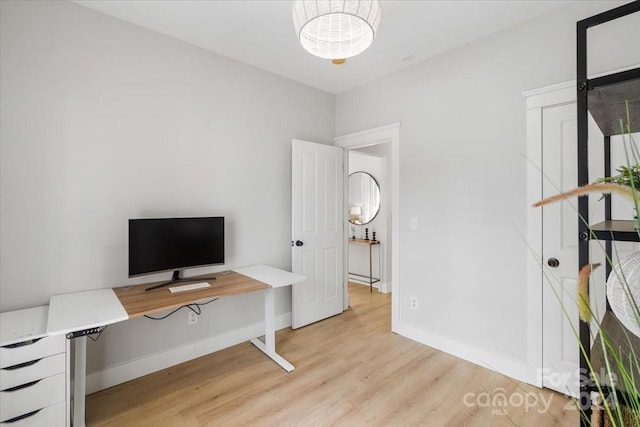 office with light hardwood / wood-style flooring