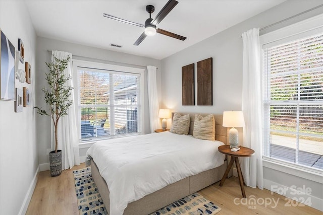 bedroom with ceiling fan and light hardwood / wood-style flooring