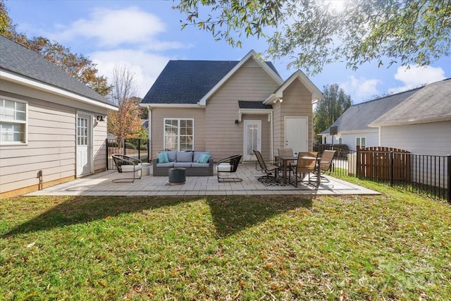 back of property with a lawn, a patio area, and an outdoor hangout area