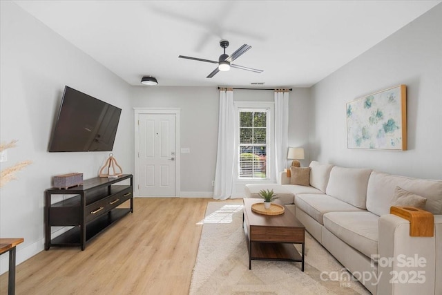 8225 Ballymore Ct, Huntersville, NC 28078 - living room with light wood-style flooring, a ceiling fan, and baseboards
