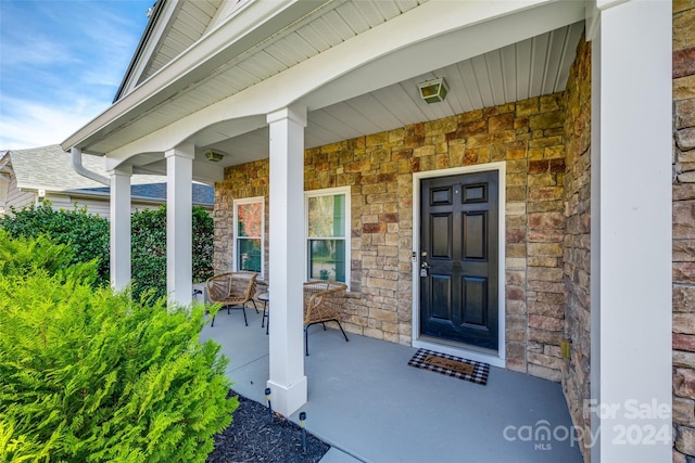 doorway to property featuring a porch