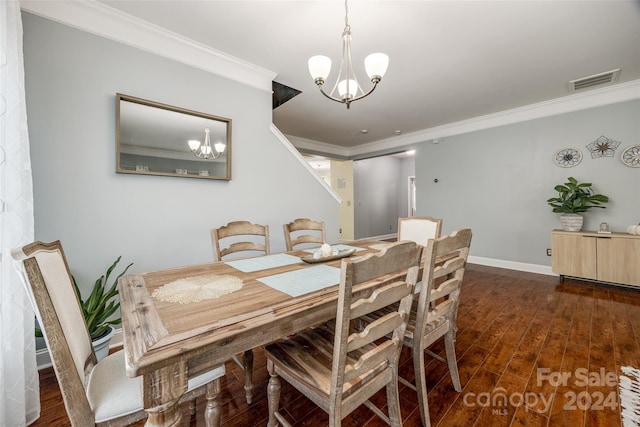 dining space with a chandelier, crown molding, and dark wood-type flooring