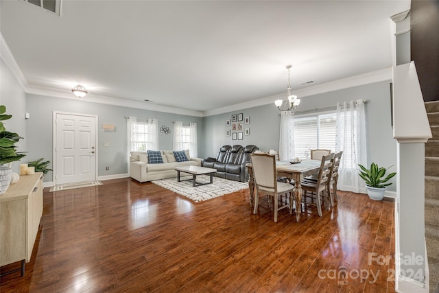 dining room featuring dark hardwood / wood-style flooring, ornamental molding, and an inviting chandelier