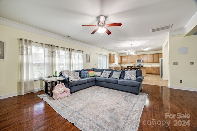 living room with hardwood / wood-style floors, ceiling fan, and crown molding