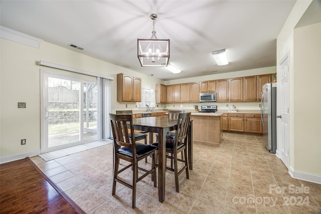 dining room with light tile patterned flooring and an inviting chandelier