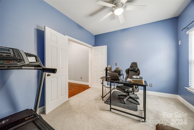 carpeted office featuring ceiling fan