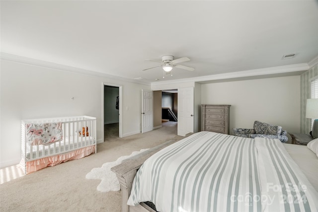 bedroom with ceiling fan, light colored carpet, and ornamental molding