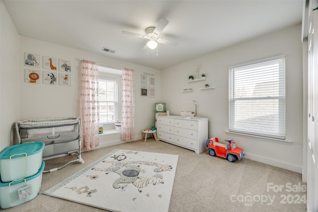 interior space with carpet floors and ceiling fan