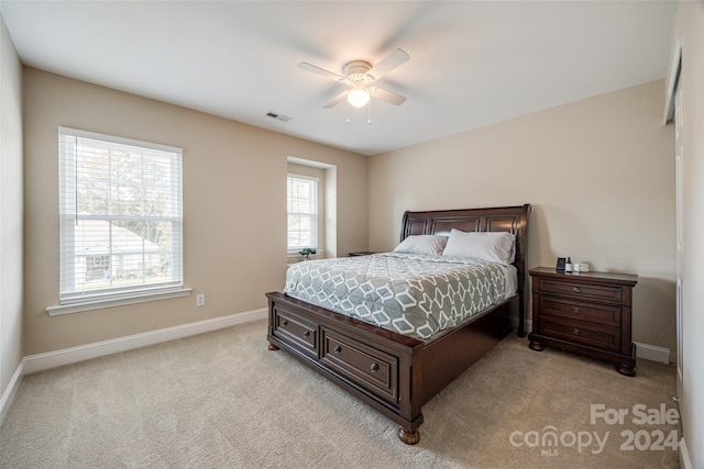 bedroom with ceiling fan and light carpet