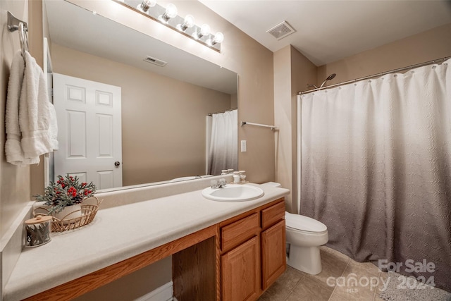 bathroom with tile patterned floors, vanity, and toilet