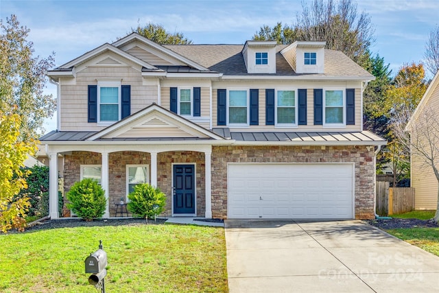 view of front of home with a garage and a front yard