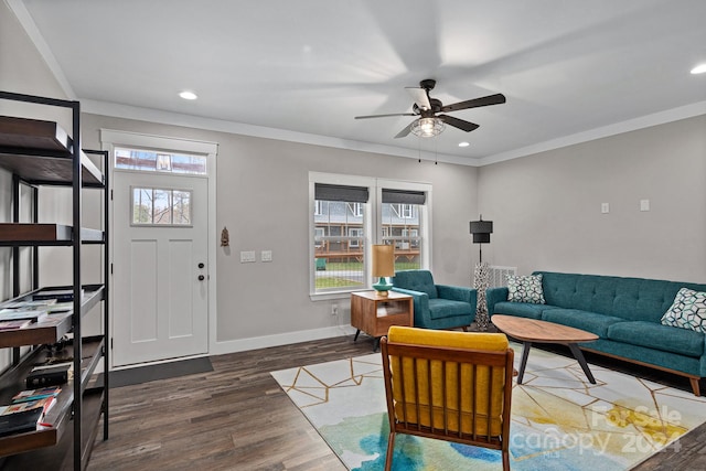 living room with ceiling fan, dark wood-type flooring, and crown molding