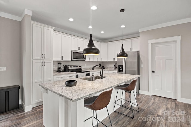 kitchen featuring light stone counters, stainless steel appliances, a kitchen island with sink, white cabinets, and dark hardwood / wood-style floors