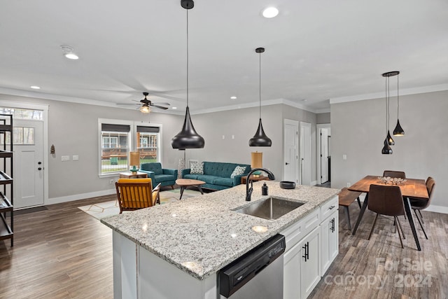 kitchen featuring dark hardwood / wood-style flooring, stainless steel dishwasher, sink, white cabinets, and an island with sink