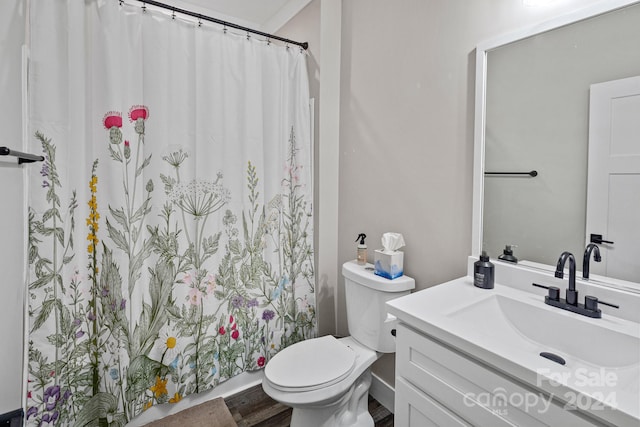 bathroom featuring hardwood / wood-style floors, vanity, toilet, and ornamental molding