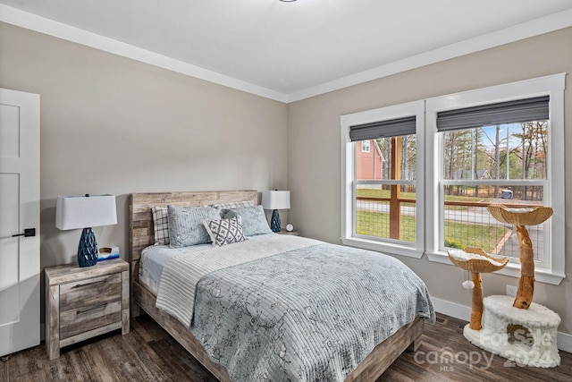 bedroom featuring crown molding and dark wood-type flooring