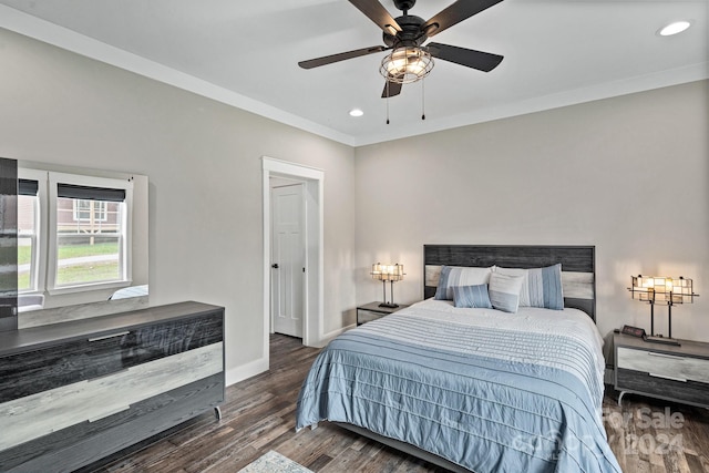 bedroom featuring ceiling fan, dark hardwood / wood-style floors, and ornamental molding