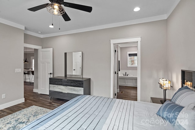 bedroom with connected bathroom, ceiling fan, dark wood-type flooring, and crown molding