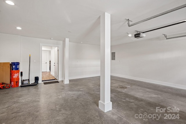 garage featuring electric panel and a garage door opener