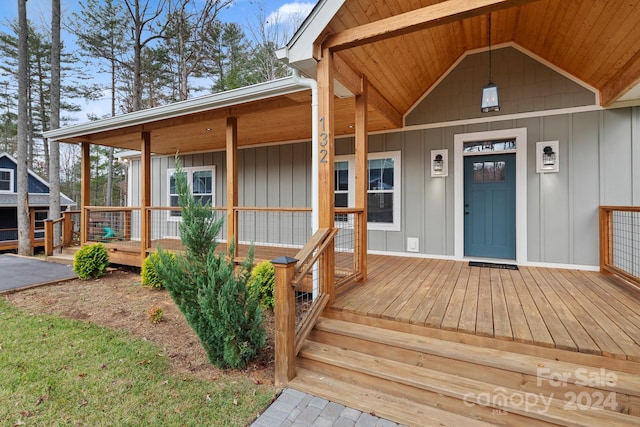 view of exterior entry with a porch