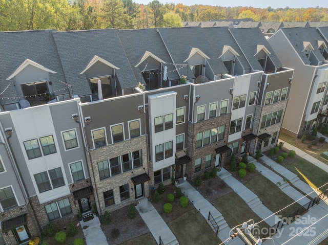 birds eye view of property with a residential view