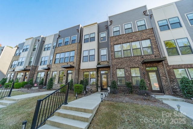 townhome / multi-family property with brick siding