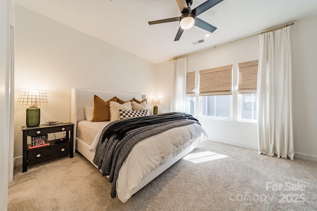 carpeted bedroom featuring visible vents, a ceiling fan, and baseboards