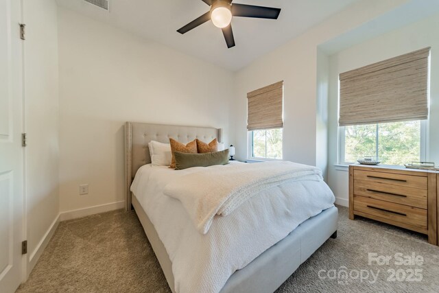 bedroom with a ceiling fan, baseboards, and light carpet