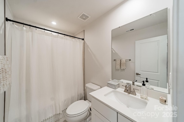 bathroom with vanity, curtained shower, toilet, and visible vents