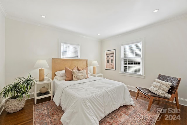 bedroom with dark hardwood / wood-style floors and ornamental molding