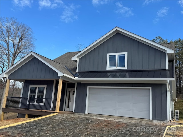 view of front of property featuring covered porch and a garage