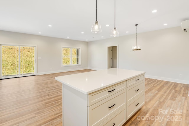 kitchen with recessed lighting, open floor plan, light countertops, hanging light fixtures, and a center island