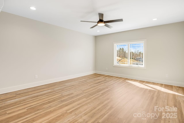 empty room with a ceiling fan, recessed lighting, light wood-style flooring, and baseboards