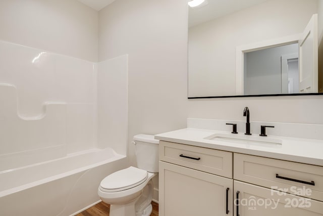 bathroom featuring shower / bath combination, vanity, toilet, and wood finished floors