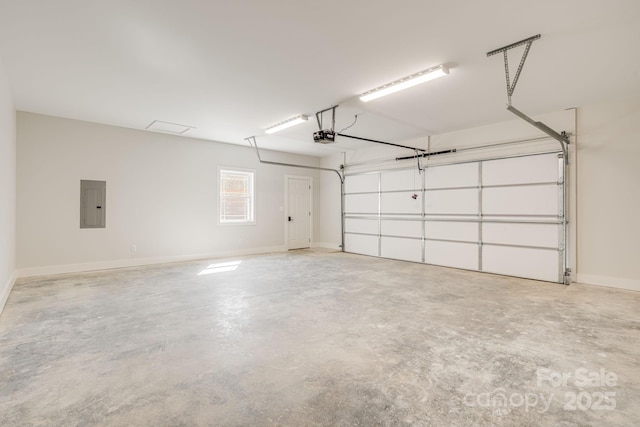 garage featuring a garage door opener, electric panel, and baseboards