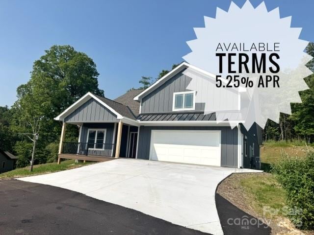 297 Bethany Dr, Mars Hill, NC 28754 - view of front of house with board and batten siding, concrete driveway, a garage, a standing seam roof, and a porch