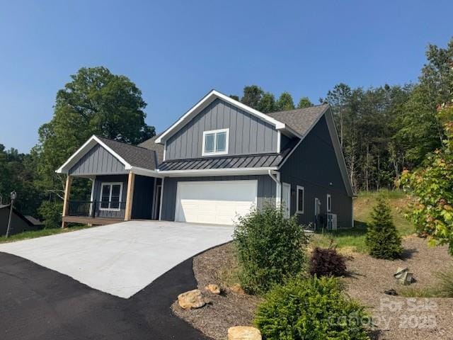297 Bethany Dr, Mars Hill, NC 28754 - view of front of house with a standing seam roof, driveway, board and batten siding, a porch, and metal roof