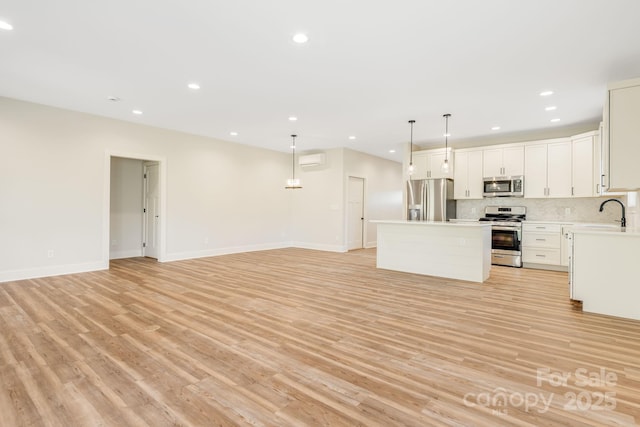 297 Bethany Dr, Mars Hill, NC 28754 - kitchen featuring stainless steel appliances, open floor plan, a center island, light wood finished floors, and recessed lighting