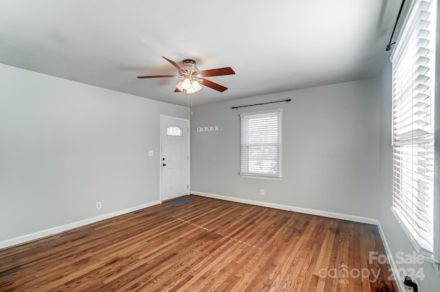 empty room featuring hardwood / wood-style flooring and ceiling fan