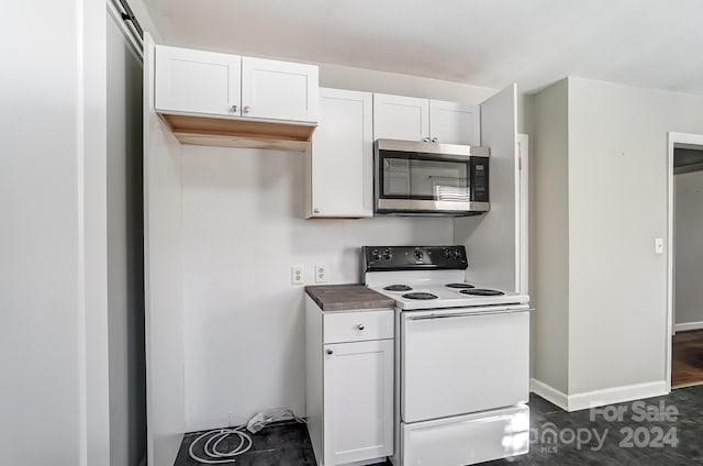 kitchen featuring white cabinetry, white electric range, and a barn door