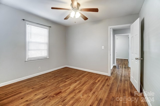 unfurnished room featuring ceiling fan and wood-type flooring