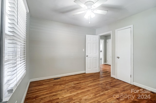 unfurnished room featuring hardwood / wood-style flooring and ceiling fan