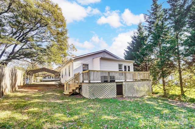 back of house with a wooden deck, a yard, and a carport